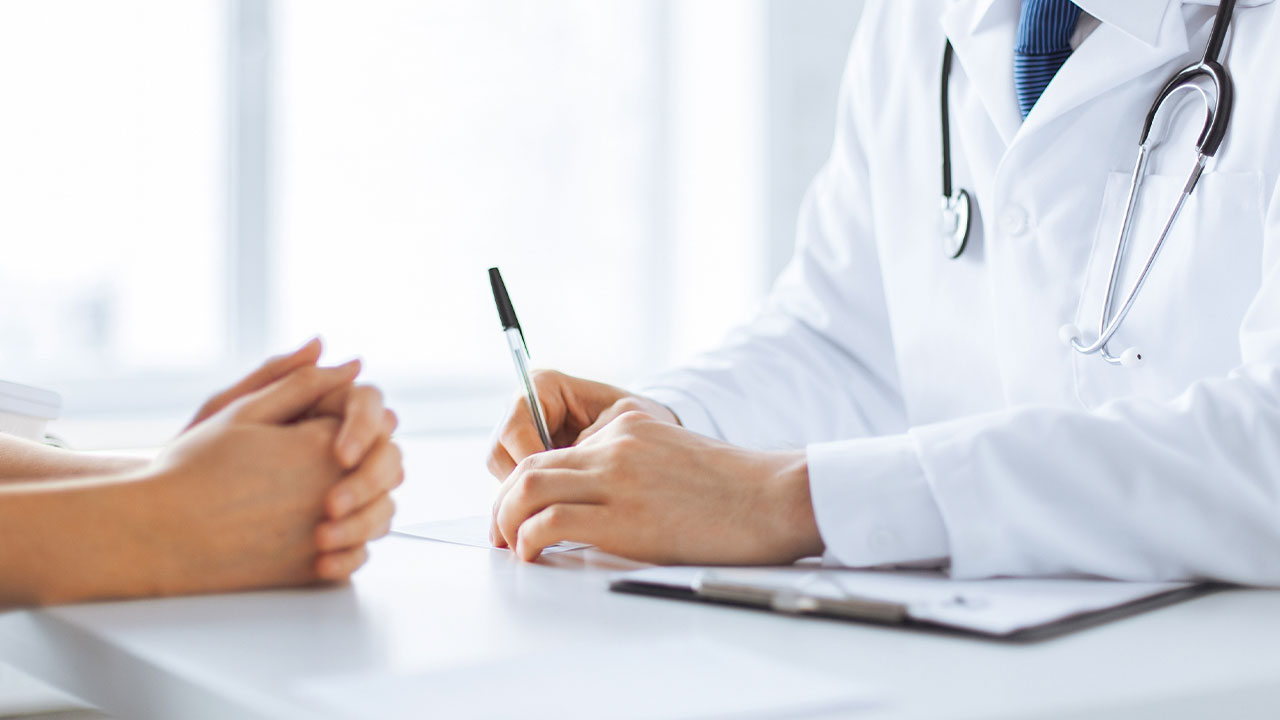 Doctors and patient hands on a table