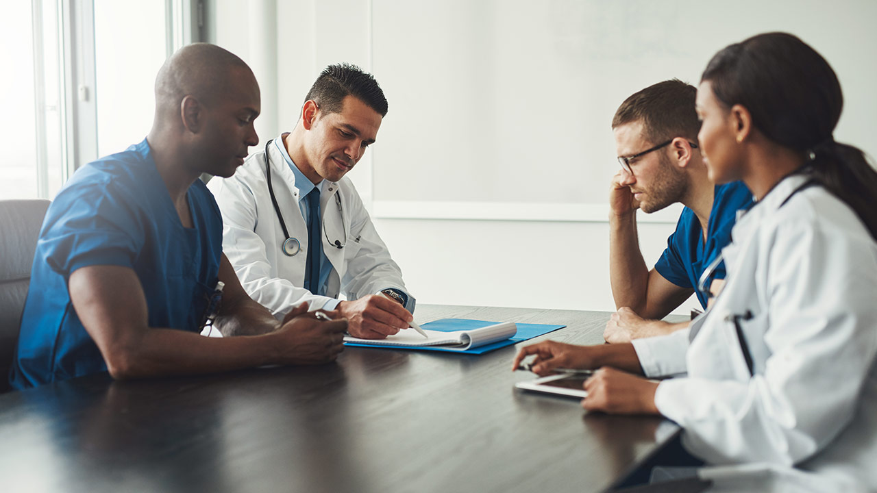 Doctors around a table discussing