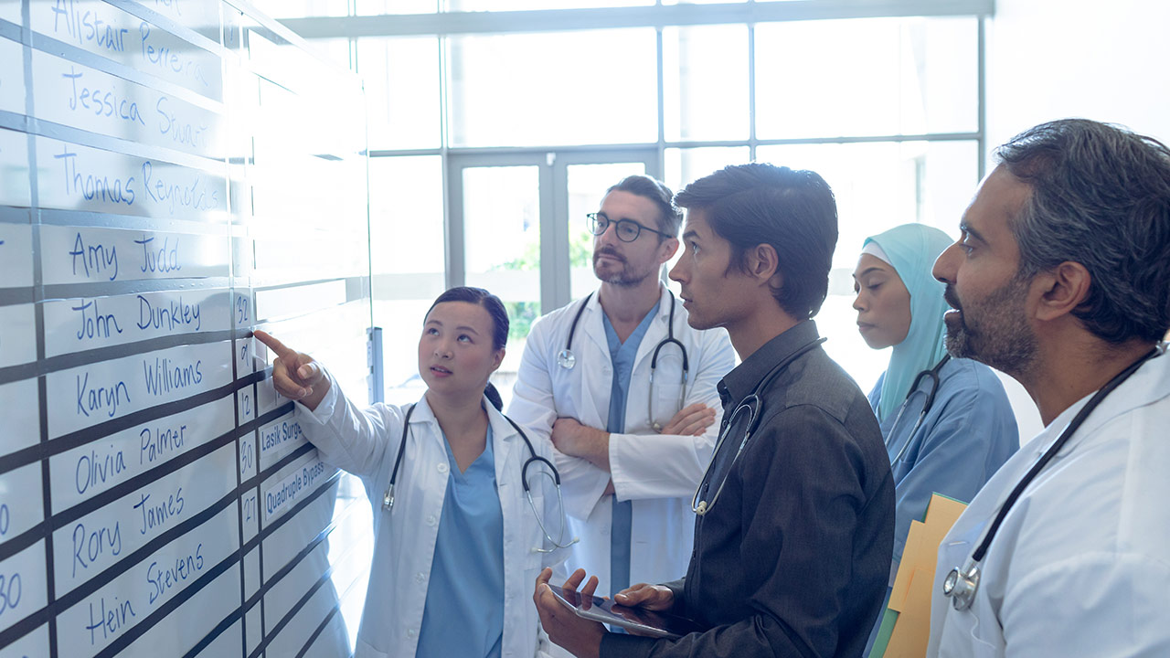 Group of doctors viewing a whiteboard together