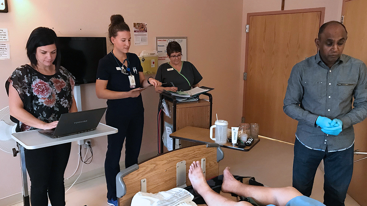 People and workers in a hospital room